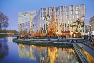 Dreischeibenhaus and Christmas market in front of the Koe-Bogen by architect Daniel Libeskind,