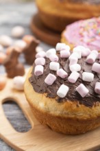 Homemade glazed and decorated easter pies with chocolate eggs and rabbits on a gray wooden