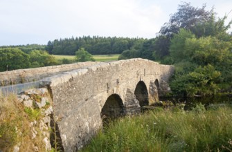 Historic Packhorse bridge at Postbridge, Dartmoor national park, Devon, England crossing the East