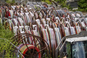 Cable drums with conduits for fibre optic cables, in a storage yard, North Rhine-Westphalia,