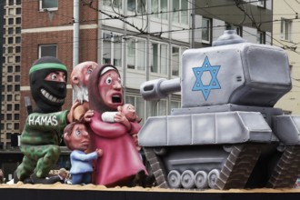 Hamas terrorist hides behind civilians in front of an Israeli tank, papier-mâché figures, satirical