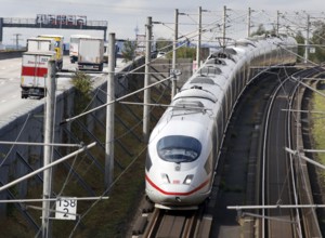 A Deutsche Bahn ICE train passes cars on the A3 motorway, Flörsheim, 28/09/2020