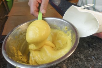 Swabian cuisine, preparing mini choux pastries, filling raw choux pastry into piping bags, eclairs,