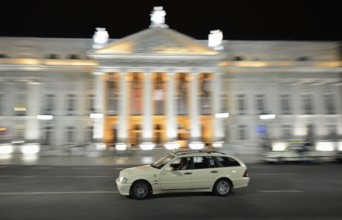 Taxi at night in front of the Teatro Dona Maria II National Theatre in Rossio Square, or Praça Dom