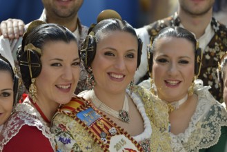 Fallas festival, women in a traditional costume during the parade in the Plaza de la Virgen de los