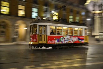 Tram, Eléctrico, travelling on the Praça do Comércio, Lisbon, Portugal, Europe