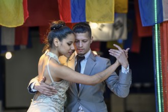 Tango dancers on the street in the port district of La Boca, Caminito, Buenos Aires, Argentina,