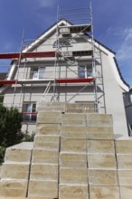 Rock wool insulation panels, stacked in front of a single-family house, cold and heat insulation,