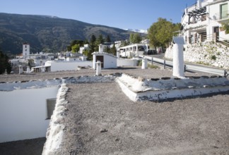 Traditional roofs and chimneys of houses in the village of Capileira, High Alpujarras, Sierra