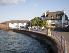 Thatched historic houses on the seafront at Paignton, Devon, England, UK