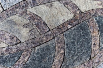 Granite mosaic maroon-black element in the park