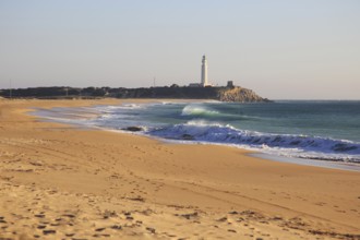 Sandy beach and lighthouse at Cabo de Trafalgar, Cadiz Province, Spain, Europe