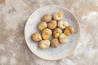 Grape (Burgundy) snails with butter and cheese on brown concrete background. Top view, flat lay