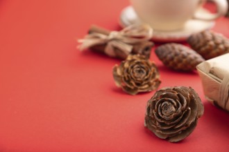 Christmas or New Year composition. Decorations, box, cinnamon, cones, fir and spruce branches, cup