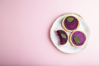 Sweet tartlets with jelly and milk cream on a pastel pink background. top view, flat lay, copy