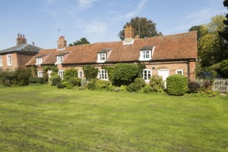 Row of red brick terraced cottages converted to one home, Orford, Suffolk, England, UK