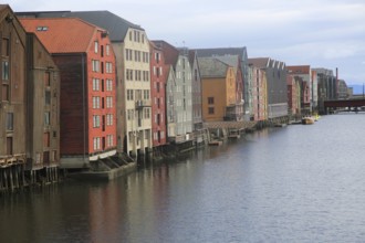 Historic waterside warehouse buildings on River Nidelva, Bryggene, Trondheim, Norway, Europe