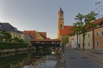 The setting sun bathes everything in warm light and reflects the Basilica of St Martin and the