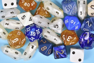 Different blue, white and golden roleplaying RPG dice