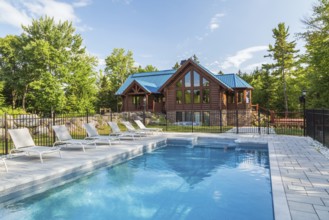 In-ground salt water swimming pool and brown stained milled Eastern white pine timber and flat log