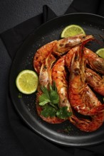 Langoustines, Australian, freshly frozen on ice, top view, lime and greens