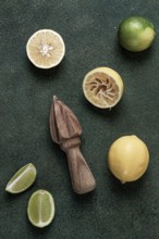 Wooden citrus reamer, manual lemon juicer, made of acacia wood, with citrus fruits on the table,