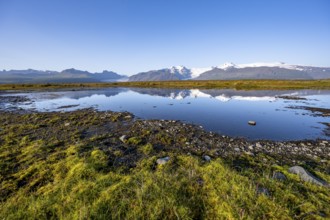 Lake with reflection, view of glacier tongues Skaftafellsjökull and Svínafellskökull, glaciated