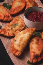 Fried mini pasties, with red sauce, top view, close-up, no people, selective focus