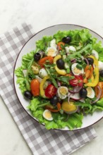 Vegetable salad, with quail eggs and olives, fresh, close-up, no people