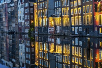 Canal houses on the Damrak, in the centre of the old town of Amsterdam, harbour, starting point of