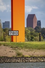 The sculpture Rhine Orange at the mouth of the Ruhr into the Rhine, skyline of the city centre of