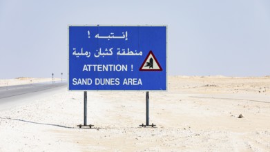 Road sign with warning of sand dunes on the Mascat-Salalah-Road, Dhofar Province, Arabian