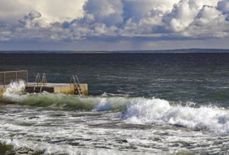 Huge waves crash against a jetty under a dramatic sky, Tönsberg, Oslofjord, Norway, Europe