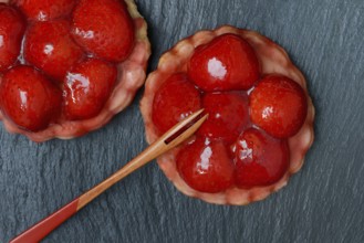 Topped strawberry tarts with a fork