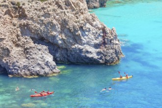 Group of people Kayaking, Tsigrado, Milos Island, Cyclades Islands, Greece, Europe