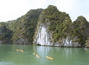 Kayakers and the karst rocks in Lan Ha Bay, Halong Bay, Vietnam, Asia