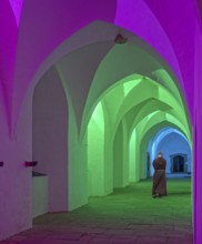 Cloister monastery colourfully illuminated with monk Möllenbeck Rinteln Germany