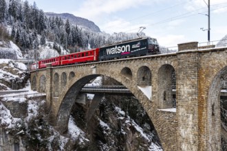 Rhaetian Railway train at the Solis viaduct of the Albula railway in the Alps in Solis,