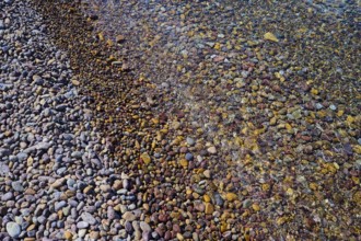 Colourful pebbles on the beach with water and different textures, Lambi beach, pebble beach,