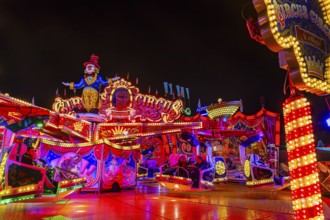 Illuminated round and elevated ride Circus Circus at standstill, night shot, Oktoberfest,