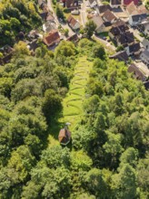 A cemetery in the forest on the edge of a village, captured from the air, Gundringen, Nagold, Black