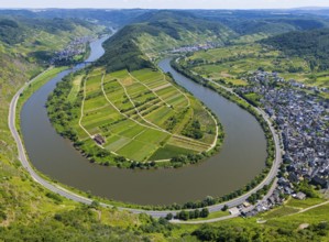 A winding river bend surrounds an agricultural landscape surrounded by hills, with a neighbouring