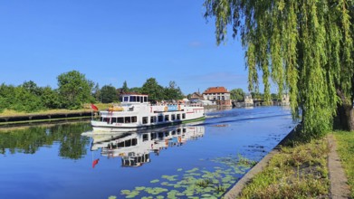 An excursion boat sailing on a calm river on a sunny day, Birkut ship, Elblag River, Elblag,