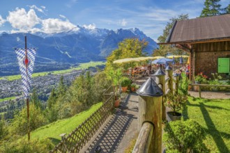 St. Martinshütte with restaurant terrace above the valley in front of the Zugspitze group 2962m,