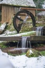 Wooden water mill with running water, snow covers the surroundings, spa gardens, Bad Wildbad, Black