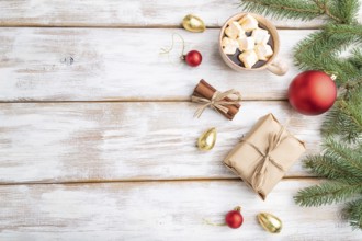 Christmas or New Year composition. Decorations, box, red balls, cinnamon, fir and spruce branches,