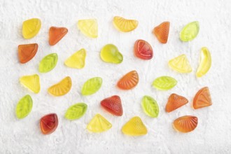 Various fruit jelly candies on gray concrete background. top view, flat lay, close up