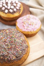 Homemade glazed and decorated easter pies with chocolate eggs and rabbits on a gray wooden