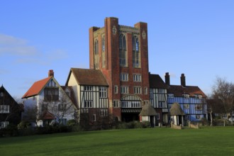 Eccentric mock Tudor architecture of water tower and houses, Thorpeness, Suffolk, England, United