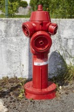 Red fire hydrant in Saint-Palais-sur-Mer, Département Charente-Maritime, Nouvelle-Aquitaine,